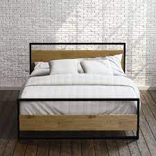 Complete with a sleek metal structure and headboard and footboard with a distinctive wood grain pattern, this foundation provides optimal support for your mattress and looks great doing it. Suzanne Metal And Wood Platform Bed Frame With Footboard Zinus