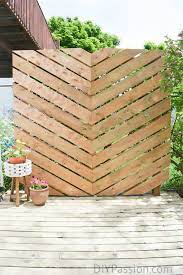 This outdoor family hangout benefits from a traditional white fence, a fireplace wall, and fetching container gardens at various heights. How To Build A Simple Chevron Privacy Wall Outdoors Diy Passion