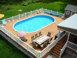 Six Chairs Around A Rectangular Table Placed On A Wooden Structure Containing A Pool Attached T In 2020 Pool Deck Plans Swimming Pool Decks Above Ground Swimming Pools