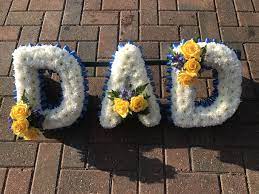 The sheaves, also known as sprays are bouquets that can be l. Blue Yellow And White Dad Funeral Flowers Tribute Wreath Funeral Flower Arrangements Funeral Flowers Dad Funeral Flowers