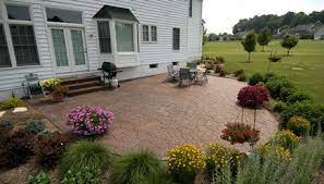 Concrete can support a lot of weight, but it cracks easily if it has to span a wide gap without support underneath. Ground Level Stamped Concrete Patio Surrounded By Shrubs And Plants Poured Concrete Patio Patio Stones Concrete Patio