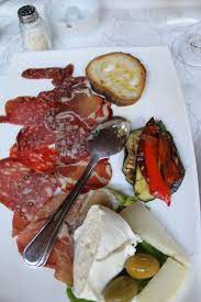 You can also order such a plate in a wine bar, where it will not necessarily be followed by a meal. Antipasti Platter At A Beautiful Outdoor Bistro By The San Sebastiano Catacombs Rome Antipasti Platter Food Eat