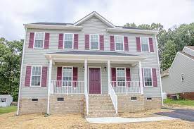 My 1960s ranch home was looking its age with its maroon shutters and maroon and cream door. Two Story Home With Gray Siding And Maroon Shutters C Balducci Builders Best Home Builders Red Shutters House Exterior