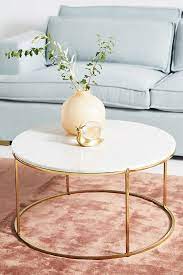 This unique, round wood coffee table would go well with any style, including the modern, farmhouse and boho! Leavenworth Petite Marble Coffee Table Anthropologie De