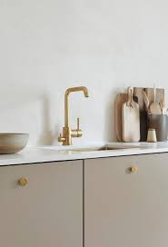 The stensund cabinet series offers lacquered doors which add a smooth and seamless look to your kitchen. Kitchen With Beige Cabinets And Brass Details My Paradissi