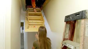 Have your helper go back down to the step ladder while you position the new door into the opening by setting it on the two pieces of scrap. How To Replace A Pull Down Attic Staircase Attic Renovation Attic Rooms Attic Staircase