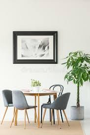 I have learned that the hard way and am trying to figure out a way to right my wrong….i painted (chalk paint) my dining room table and chairs white on the bottom/bases and a light grey on the top (table top and seats). Real Photo Of A Dining Room Interior With A Table Chairs Tree And Painting In A Black Frame Stock Photo Image Of Wood Painting 122712936