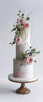 Dessert designs concocted a cake with height for this wedding, but kept the cream cheese frosting beautifully simple. These Wedding Cake Ideas Are Seriously Stunning