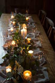 So easy and so affordable. Farm Table Decor For A Reception Using Candles Eucalyptus And Other Greens Farm Table Decor Table Decorations Farm Table