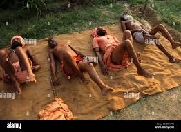 Dhaulpur, India. 21st June, 2015. Naga Sadhu (Naked holy man) perform yoga  to the villagers on first world yoga day at Dhaulpur. Naga Sadhus are a  particular group of Shaivite saints who