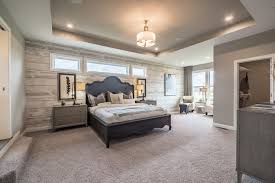 You Ll Love The Owner S Retreat In This New Home A Wood Wallpaper Feature Wall Tray Ceiling Sitting Area And Dual Walk Bedroom Layouts Wood Wallpaper Home