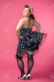 Mature Pin-up Woman Wearing 50s Style Dress, Pink Background Stock Photo,  Picture And Royalty Free Image. Image 28866667.