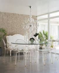 Imagine ocean breezes and good conversation around this stunning lucite palm beach dining table. Fine Dining Elle Decor Designer Michael Moloney Dining Room Contemporary Louis Ghost Chair Ghost Chairs