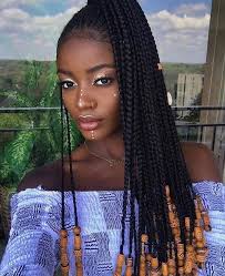 Two cute little girls are sitting next to each other on a pink background in the studio. Cute Braided Hairstyles For Black Girls Trends Hairstyle