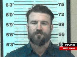 Zeppelin the happy criminal smiling for his mugshot