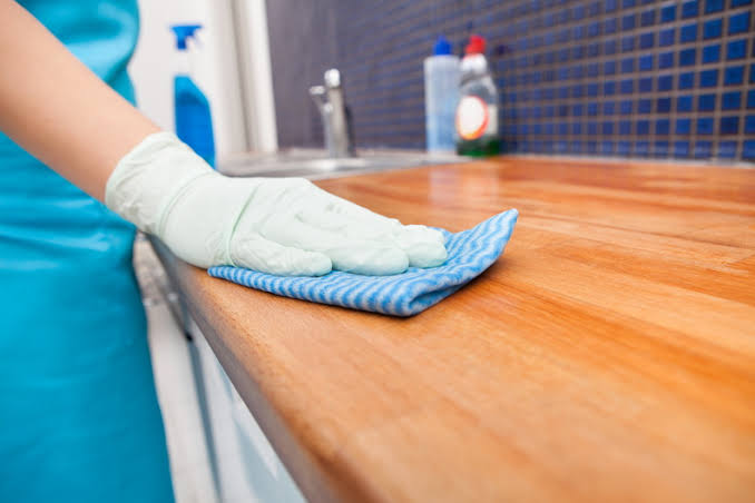 Homeowner enjoying a spotless living space after scheduling a trusted cleaning service near me with Neat Nest Cleaning Co's experienced cleaning professionals.