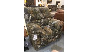Straps with clips are applied to camo couch covers to prevent the fabric from sliding off of the furniture. Camo Recliner