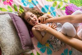 Mother and daughter receive foot care from dr. Mother Daughter Bed Tickle Stock Photos Offset
