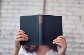 Selective Focus Photography of Woman Holding Book · Free Stock Photo