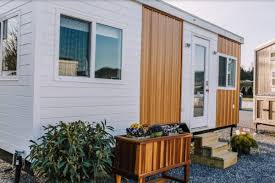 Its interior features a wide, open floor plan with two bedrooms; Titan Tiny Homes Tiny House Talk