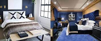 Navy and beige bedroom features walls painted navy blue lined with a beige nailhead bed dressed in white and grey bedding blanked by espresso nightstands illuminated. Top 50 Best Navy Blue Bedroom Design Ideas Calming Wall Colors