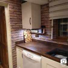 White kitchen cabinets with a blue gray island and carrara marble countertops. Rustic Brick Red Effect Wall Panel Decor Walls Flooring