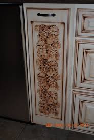 This is traditional style cabinetry. Grape Vine Carving On Cabinet Door Cabinet Doors Tuscan Kitchen Design Tuscan Kitchen
