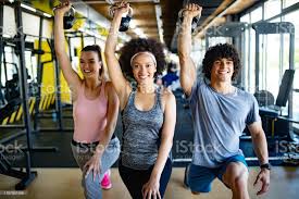 ✓ Group of healthy fit people training in gym Stock Photos