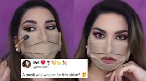 woman applies makeup on surgical face