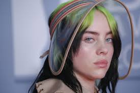Shock of green hair has gone blonde and full bombshell, swapping her trademark sweats for a style more domme than deb: Billie Eilish Reveals Massive Hip Tattoo In British Vogue Cover Shoot See Photo Allure