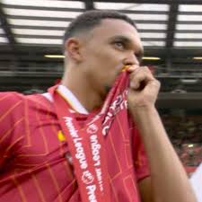 Trent Alexander-Arnold kissing the Liverpool badge after getting his  Premier League medal.