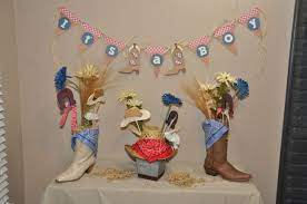 Boy Baby Shower Decorations With Boots And Cowboy Hats Cowboy Baby Shower Cowboy Theme Baby Shower Boy Baby Shower Themes