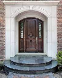 This design draws the viewer's eye to the front door entrance by framing it with grecian urns planted with dwarf alberta spruces. Front Door Makeover Reinvent Your Entryway House Entrance Doors Front Door Design Main Door Design