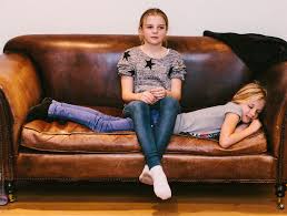 It measures 33 x 81 x 35 inches and weighs just under 200 pounds, so it is a heavy sofa that will require multiple people to set up or move. Sisters On An Old Leather Sofa By Helen Rushbrook