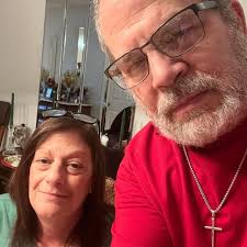 The photo shows two people. A man and a woman standing side by side. The  photo is a still from a popular TV show called The Dating Game, which aired  in the