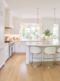 Light tone hardwood flooring and wooden bar stool balances the design scheme. Best Of Wayfair S Memorial Day Sales Kristywicks Com Kitchen Cabinets Light Wood Wood Floor Kitchen Light Wood Kitchens