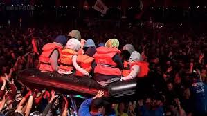 Banksy let loose inflatable boat with dummy migrants onto crowd at  Glastonbury during Idles gig - as band say they were unaware of stunt until  they left the stage | Daily Mail Online