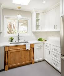 Popular white kitchen cabinets gleam with pizzazz, do you agree? Caramel Stained Sink Cabinets With White Perimeter Cabinets Transitional Kitchen