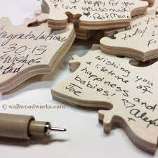 Message and text engraved on the largest piece in the middle of wooden puzzle. Letter Wedding Puzzle Guest Book Wall Woodworks Company