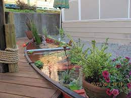 A whole row of flip flop planters would look quite stunning. The Canoe Pond Backyard Garden Outdoor Gardens