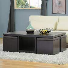 The stools, four in total, are upholstered in dark brown leather and have solid wood bases that can double as shelves, forming storage compartments for each of the guests. Prescott Table And Stool Set With Hidden Storage In Dark Brown Walmart Com Walmart Com