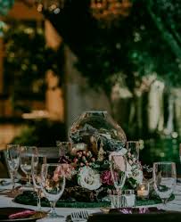 Wood reception tables with bud vase centerpieces. Melted Glass Terrarium Centerpiece With Fresh Floral Occasions By Shangrila
