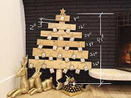 This is a really easy project and looks so gorgeous surrounded by candles and other decorations. Remodelaholic Diy Pallet Wood Christmas Tree Advent Calendar Day 11