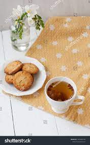 A Tasty Snack A Cup Of Tea With Dried Fruits A Plate Of Cookies A Bouquet Of White Flowers On A Golden Ad Ad Dried Fr Yummy Snacks Dried Fruits Tasty
