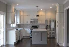 Kitchen Has White Shaker Cabinets On The Perimeter Gray Marble Backsplash Soft Gr Kitchen Cabinets Grey And White Gray And White Kitchen White Shaker Kitchen