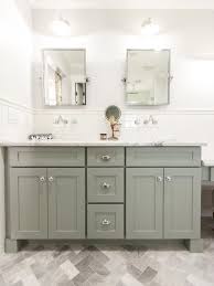 The space surrounding the freestanding tub makes the room feel more open, as does the lightweight curtain fabric, which allows maximum light to enter. Love The Sage Green Cabinets Floor Tile White Subway Tile Bathroom Cabinets Designs Small Bathroom Decor Craftsman Bathroom