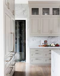 Marble Waterfall Countertop With Beige Kitchen Cabinets Luxury Kitchens Home Kitchens Kitchen Interior