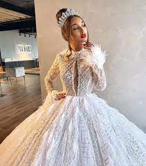 Cap sleeve off the shoulder ball gown wedding dress with beaded bodice and tulle sparkle skirt. Ostrich Feather Sparkling Ball Gown Wedding Dress Slaylebrity