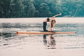 Why Stand Up Paddle Board Yoga Is The Best Summer Workout Paddle Board Yoga Standup Paddle Paddle Boarding
