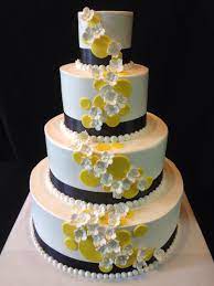 Wedding Cake With Smooth Icing And Navy Blur Ribbon With Yellow Fondant Accent Dots And White Gumpaste Flowers Smooth Icing Wedding Cakes Fondant